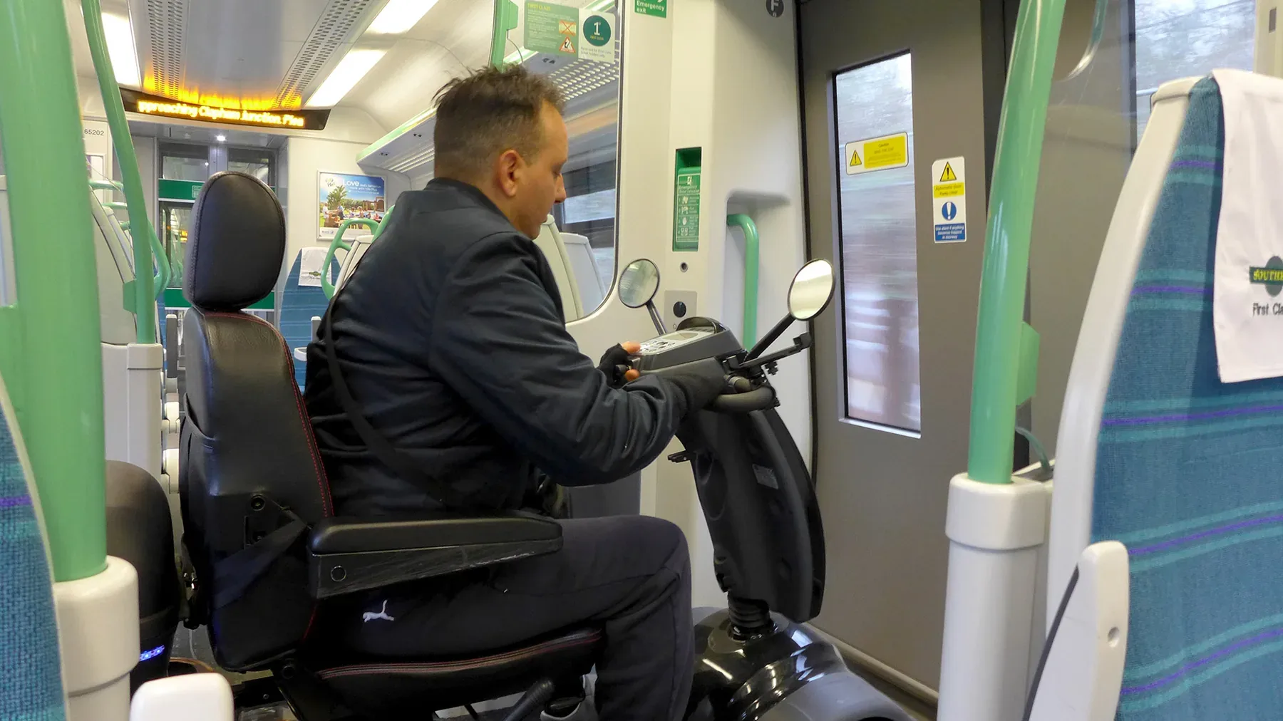 Mobility scooter user navigating train carriage